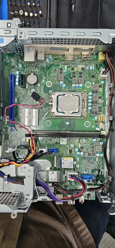 Desktop motherboard with CPU socket exposed during repair